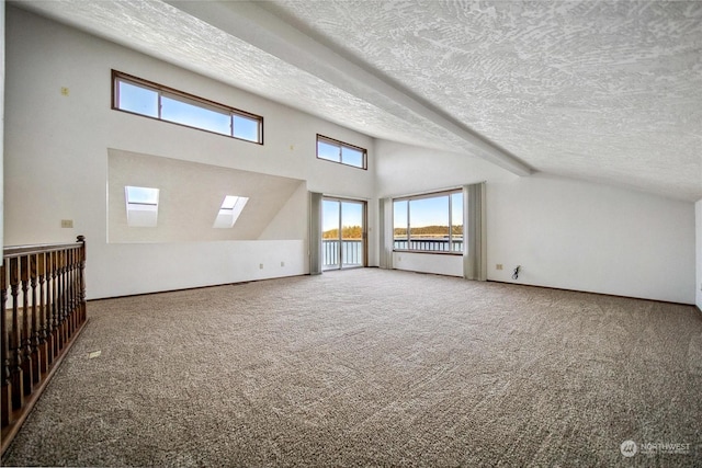 additional living space featuring vaulted ceiling, carpet floors, and a textured ceiling