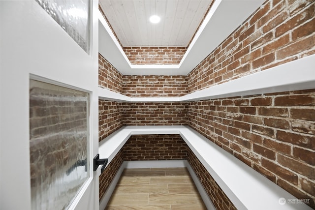 interior space featuring brick wall