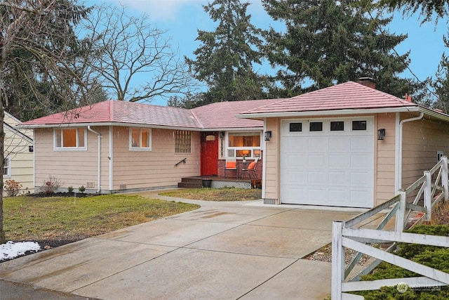 ranch-style home with a garage and a front lawn