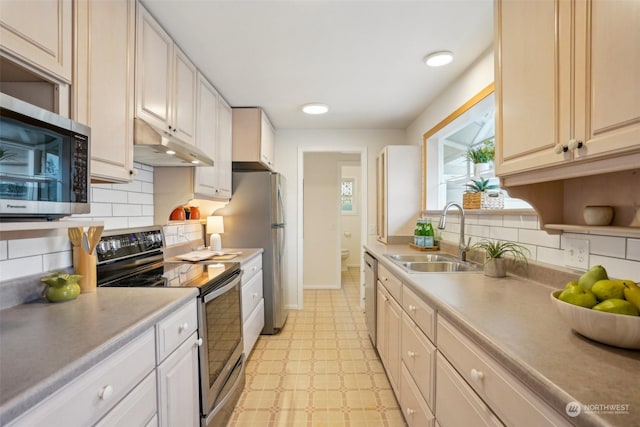 kitchen featuring tasteful backsplash, appliances with stainless steel finishes, and sink