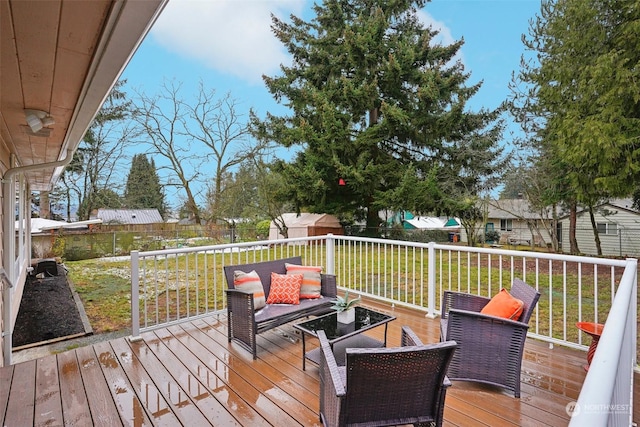 deck with an outdoor hangout area and a lawn