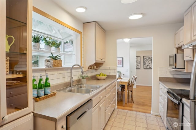 kitchen featuring tasteful backsplash, appliances with stainless steel finishes, sink, and white cabinets