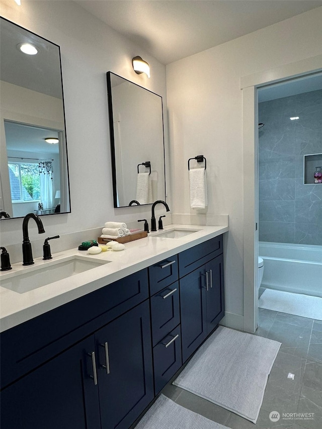 full bathroom featuring vanity, toilet, and tiled shower / bath combo