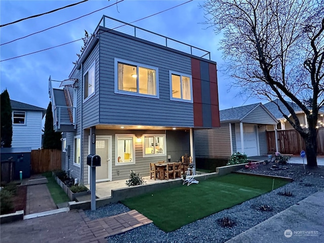 rear view of property with a garage and a patio