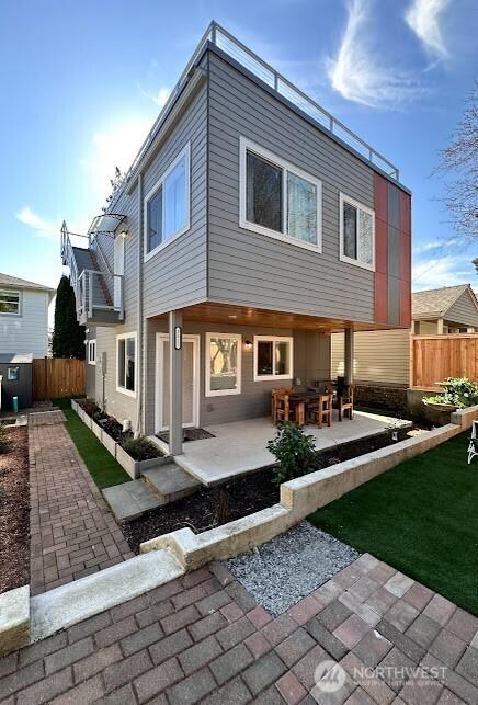 back of property with a patio area and fence