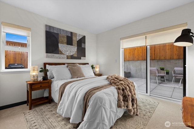 bedroom with access to outside, baseboards, and light colored carpet