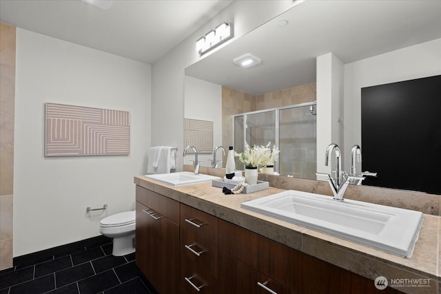 bathroom featuring a shower stall, a sink, toilet, and tile patterned floors