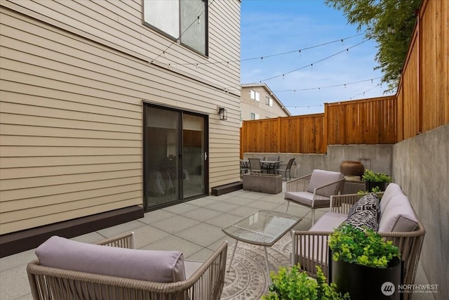 view of patio with fence and outdoor lounge area