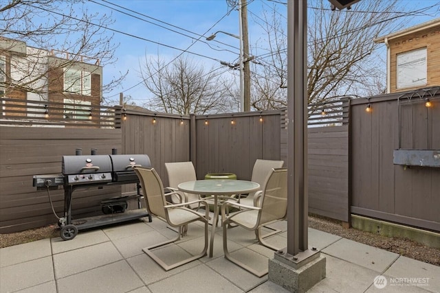 view of patio / terrace featuring outdoor dining area, a fenced backyard, and area for grilling