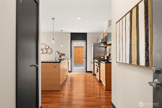 kitchen with high end stainless steel range, dark countertops, wood finished floors, and modern cabinets