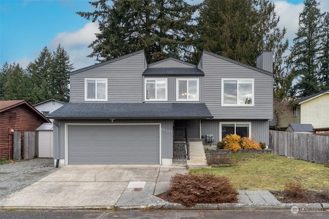 view of front of house featuring a garage and a front lawn