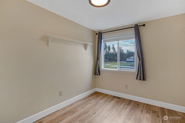 spare room featuring light hardwood / wood-style floors