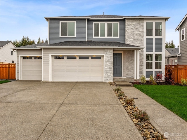 prairie-style home with a garage and a front yard