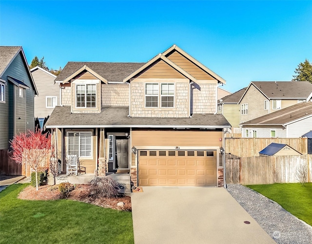 view of front of home with a garage, a porch, and a front yard