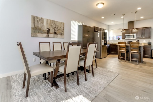 dining space featuring light hardwood / wood-style floors