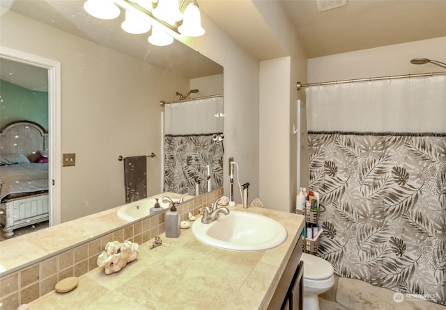 bathroom with vanity, a shower with shower curtain, a notable chandelier, and toilet