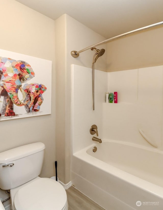 bathroom featuring shower / bathing tub combination, wood-type flooring, and toilet