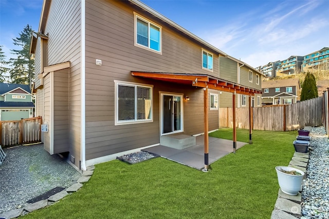 rear view of house with a yard and a patio area