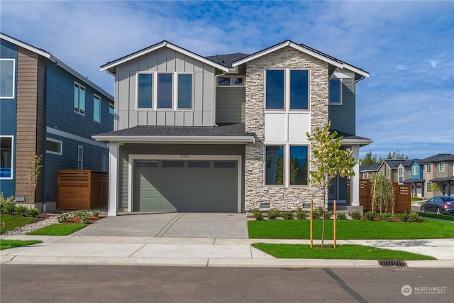 view of front of property with a garage and a front lawn