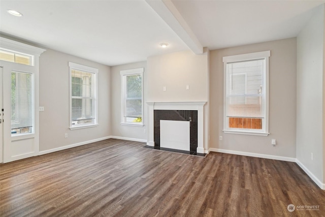 unfurnished living room with beam ceiling, a premium fireplace, and dark hardwood / wood-style floors