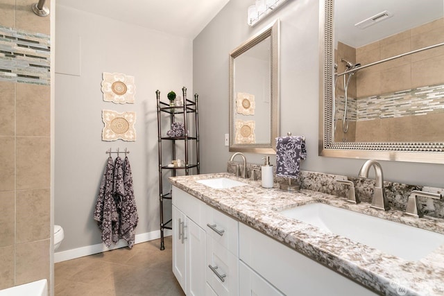 bathroom with vanity, tile patterned flooring, and toilet