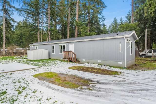 view of snow covered rear of property