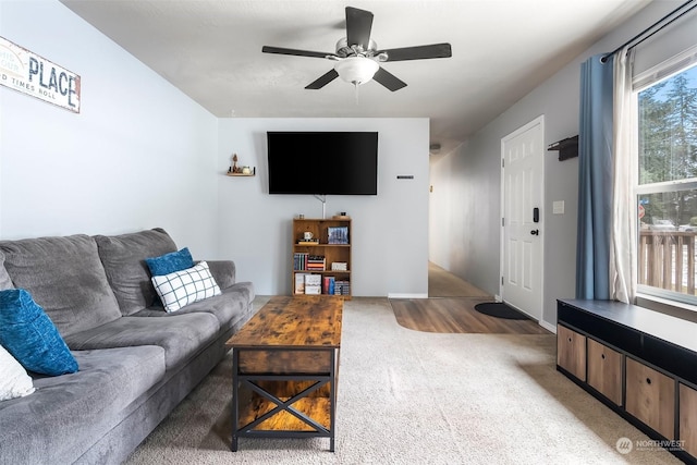 carpeted living room featuring ceiling fan