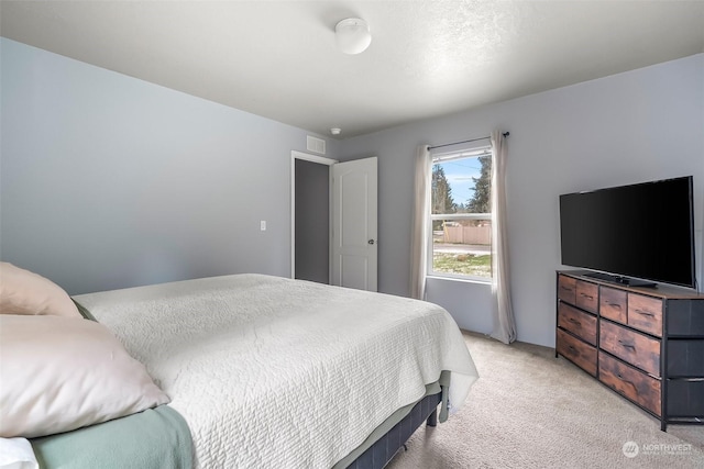 bedroom featuring light carpet