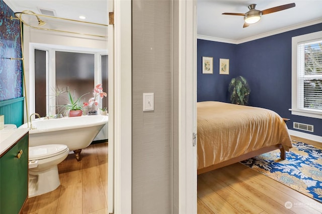 bedroom featuring crown molding, ceiling fan, and wood-type flooring