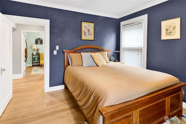 bedroom featuring crown molding and light hardwood / wood-style flooring