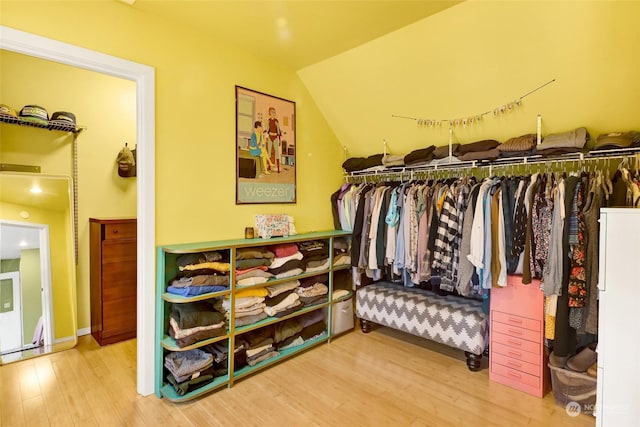 spacious closet featuring lofted ceiling and hardwood / wood-style floors