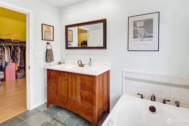 bathroom with vanity and a bathing tub