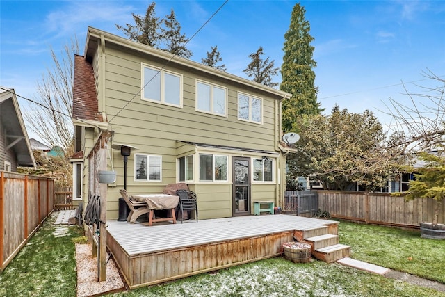 back of house featuring a wooden deck and a lawn