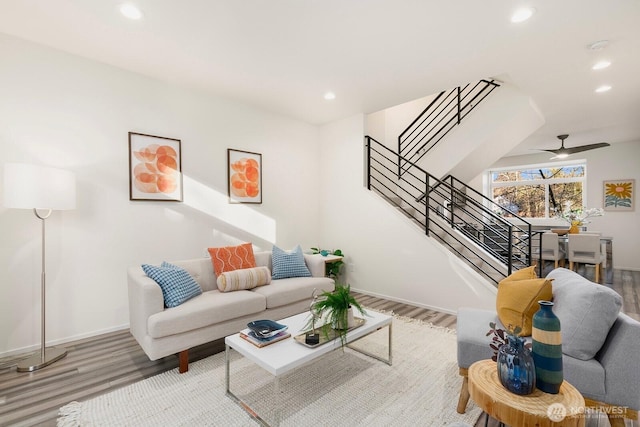 living room featuring hardwood / wood-style floors and ceiling fan