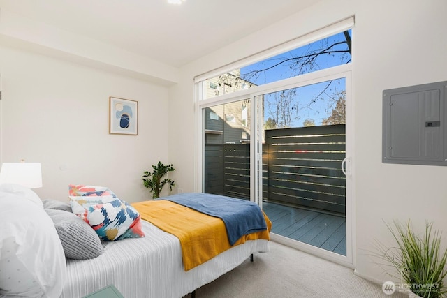 bedroom featuring access to exterior, electric panel, and carpet floors