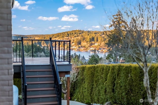 wooden terrace featuring a water view