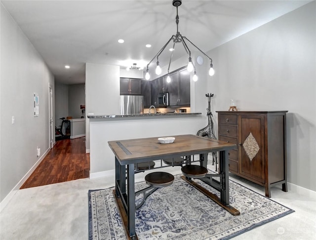 carpeted dining area featuring sink