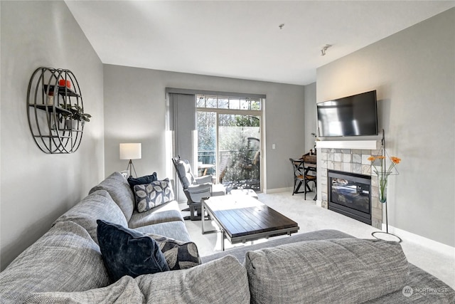 carpeted living room featuring a tile fireplace