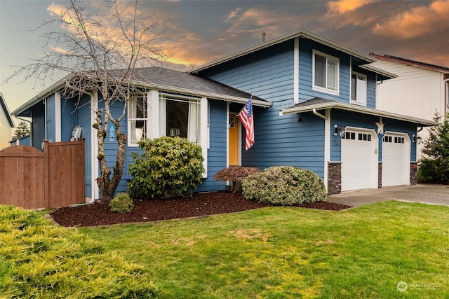 view of front of property featuring a yard and a garage