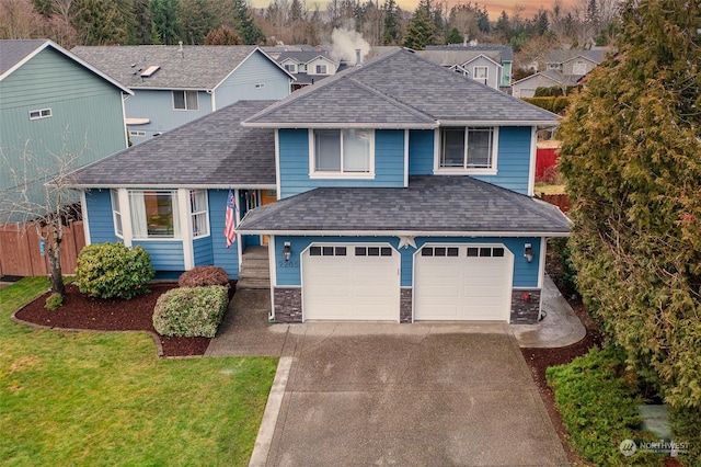 view of front of house featuring a yard and a garage