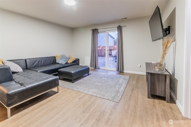 living room with light hardwood / wood-style flooring