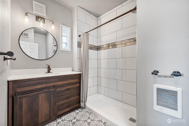 bathroom featuring tile patterned flooring, vanity, heating unit, and walk in shower