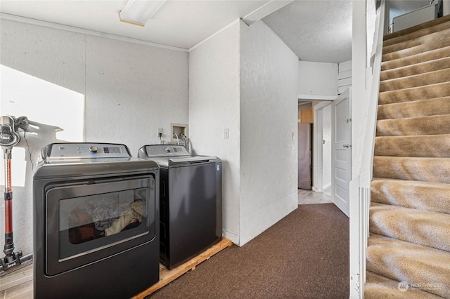 laundry area featuring carpet floors and washing machine and dryer