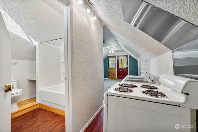 kitchen with dark wood-type flooring, lofted ceiling, sink, a textured ceiling, and white range with electric stovetop