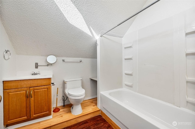 full bathroom featuring lofted ceiling, toilet, a textured ceiling, vanity, and hardwood / wood-style floors