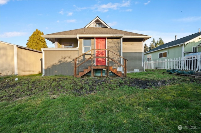 back of house featuring a lawn