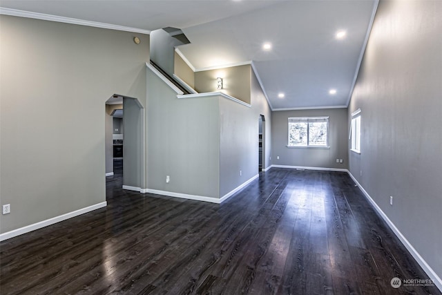 spare room with crown molding, vaulted ceiling, and dark hardwood / wood-style floors