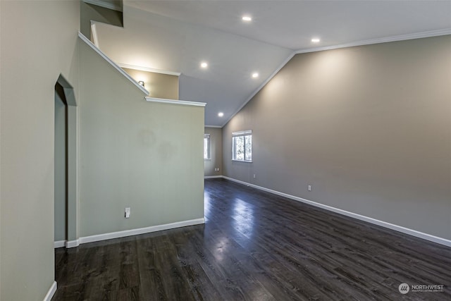 unfurnished room with dark wood-type flooring, ornamental molding, and high vaulted ceiling