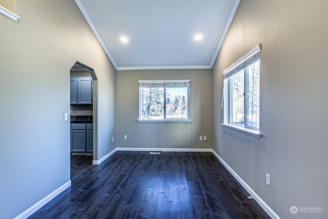 unfurnished living room featuring crown molding and dark hardwood / wood-style flooring