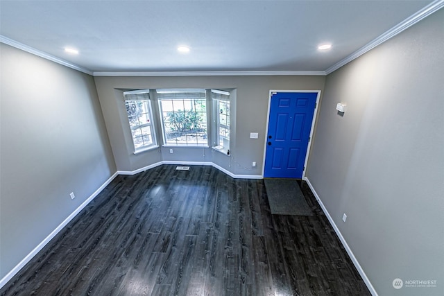 foyer with ornamental molding and dark wood-type flooring